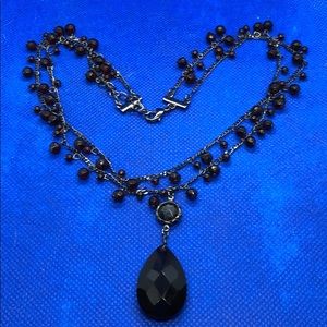 Silver necklace with red beads.